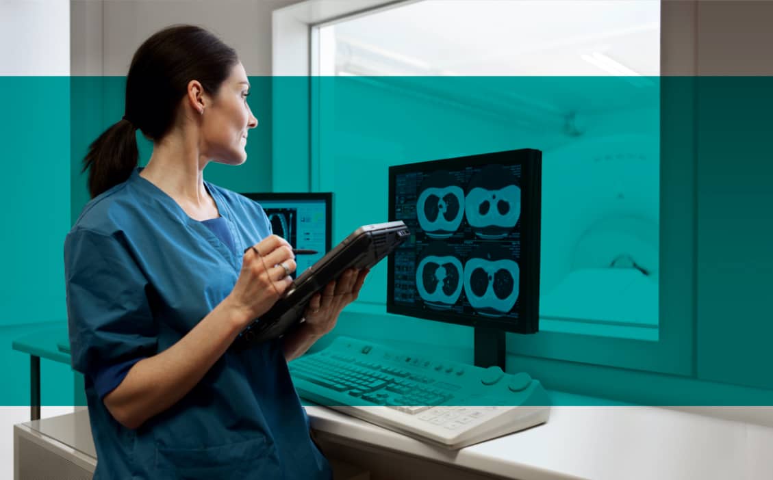 Woman radiologist viewing lung CT scans on video monitor