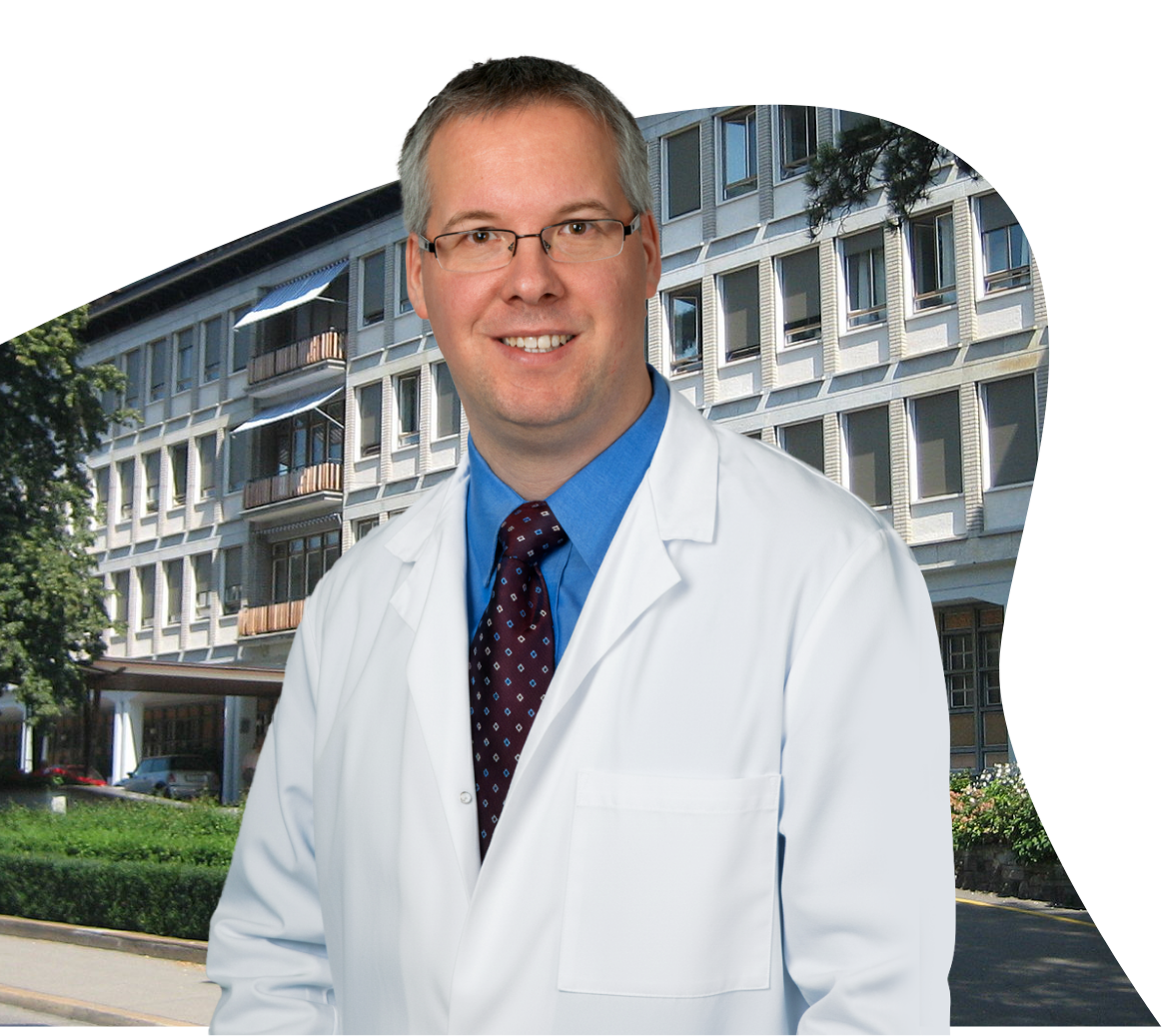 Doctor photographed at a healthcare campus entrance, representing the clinical professionals who trust Riverain Technologies ClearRead solutions.