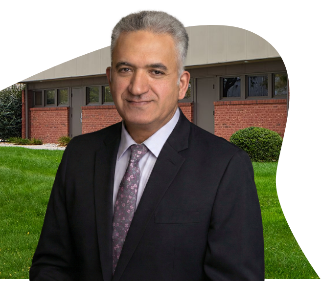 Professional portrait of Dr. Ehab Youssef, MD, PhD, MBA, FRCR, at a medical facility, a thoracic radiologist partnering with Riverain Technologies for ClearRead CT implementation.