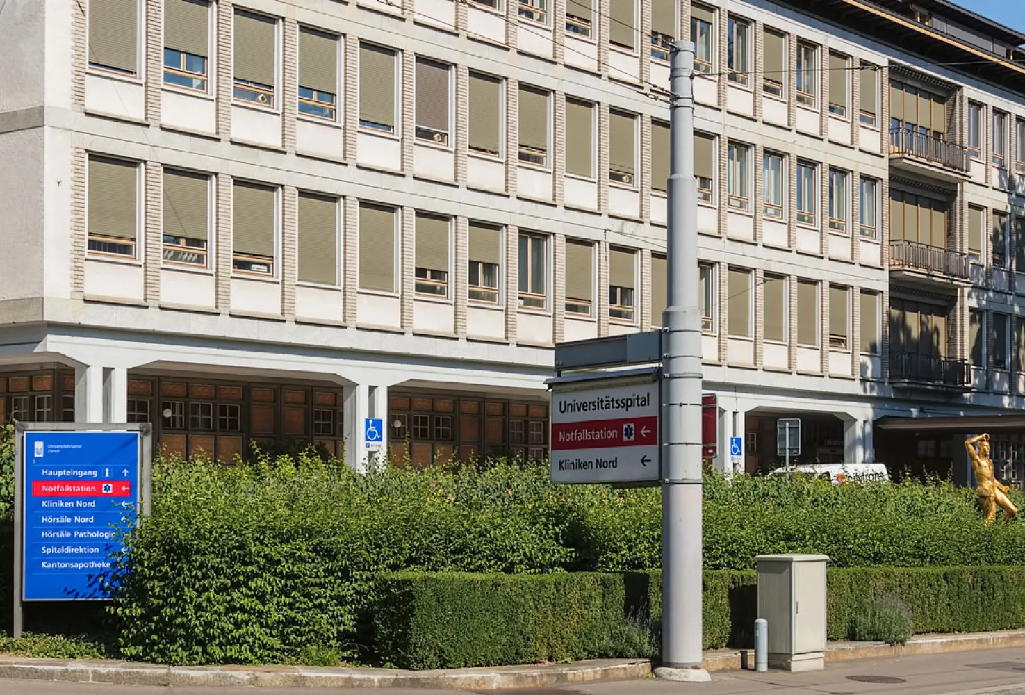 The facade of the University Hospital of Zurich with blue directional signs, showcasing an international Riverain Technologies partner deploying ClearRead diagnostic solutions.